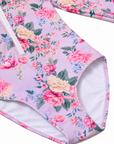 Close-up of the lined leg opening and Violetta purple floral print on the Girls Long Sleeve Zip One Piece