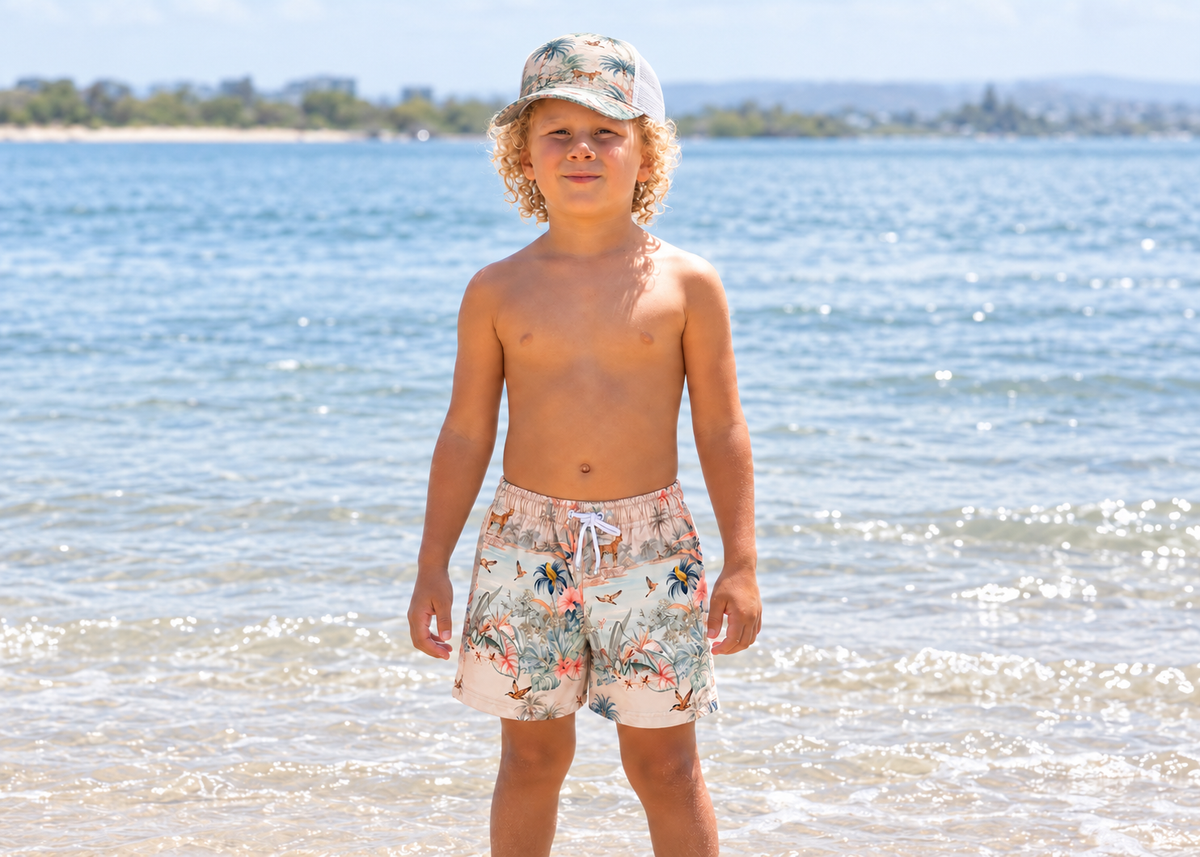 Boy wearing the Olga Valentine Wild Palms mesh trucker cap at the beach