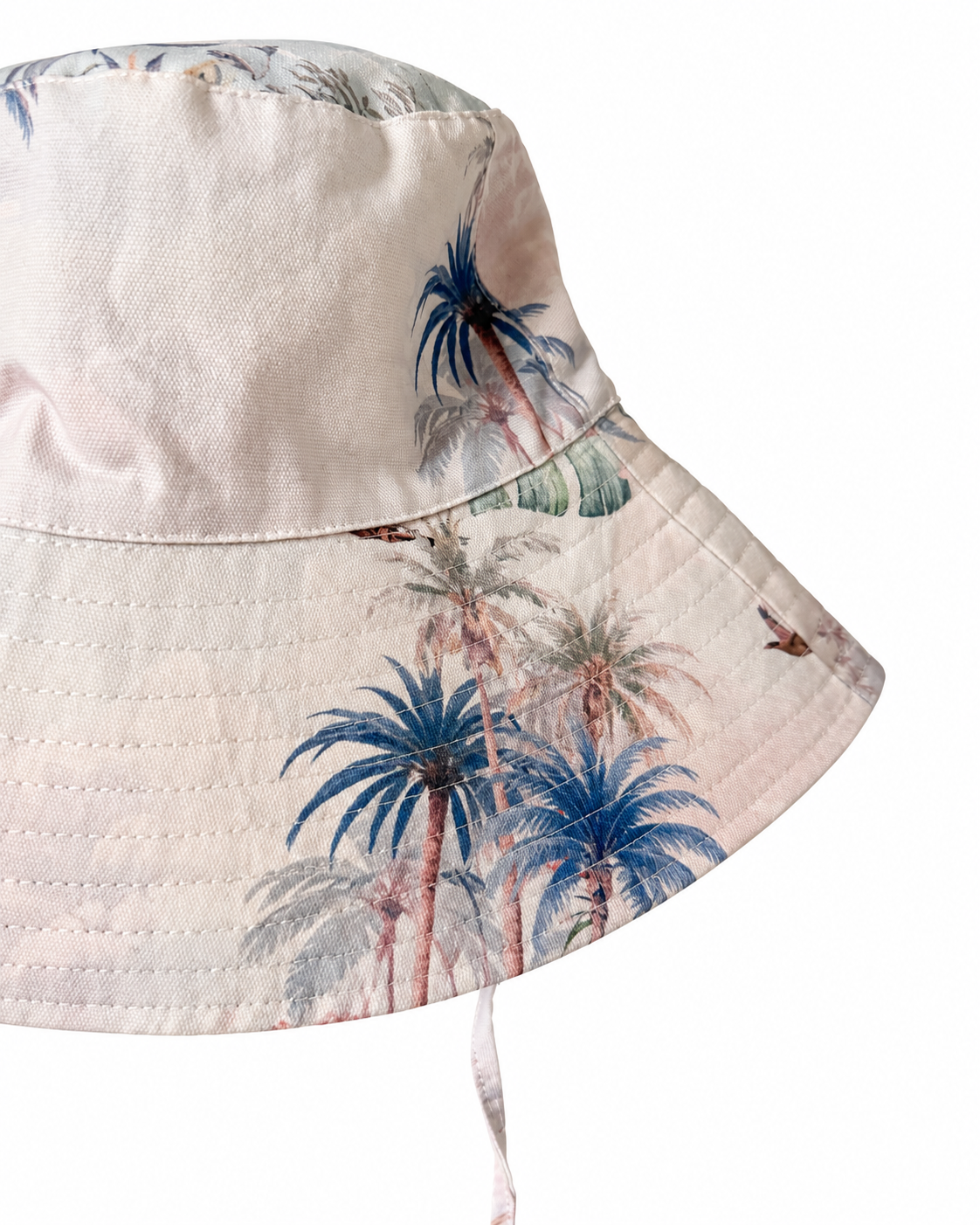 Close-up of Wild Palms bucket hat showing palm tree print, woven fabric and stitched brim