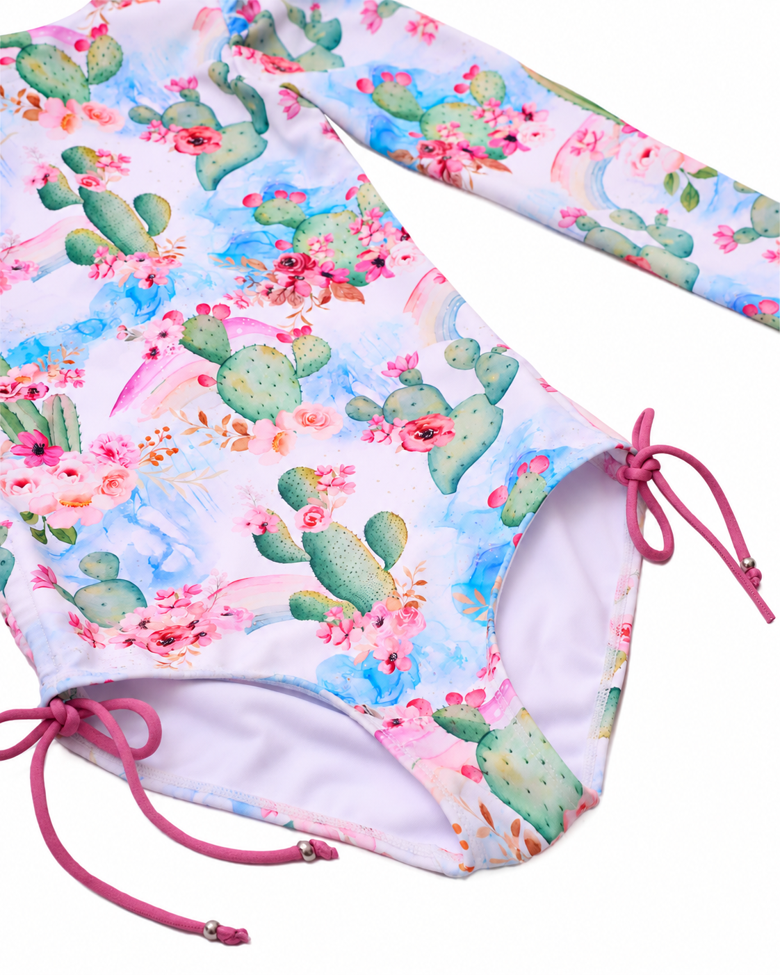 Close-up of the Taormina Bloom one-piece swimsuit showing the cactus floral print, lining and pink side ties.