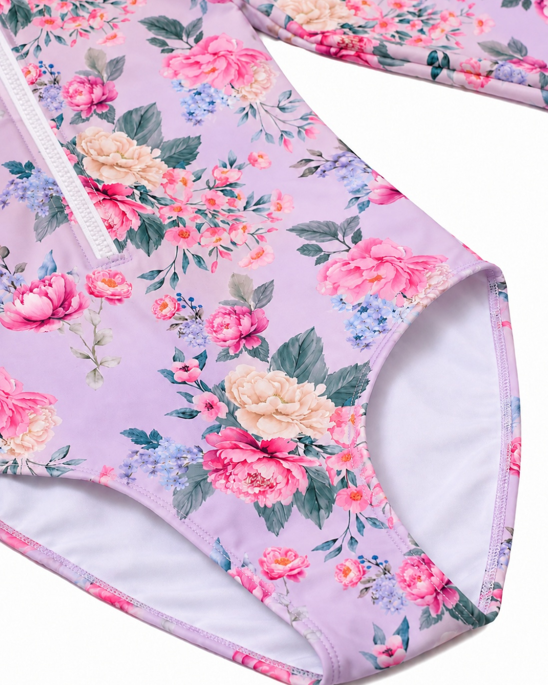 Close-up of the lined leg opening and Violetta purple floral print on the Girls Long Sleeve Zip One Piece