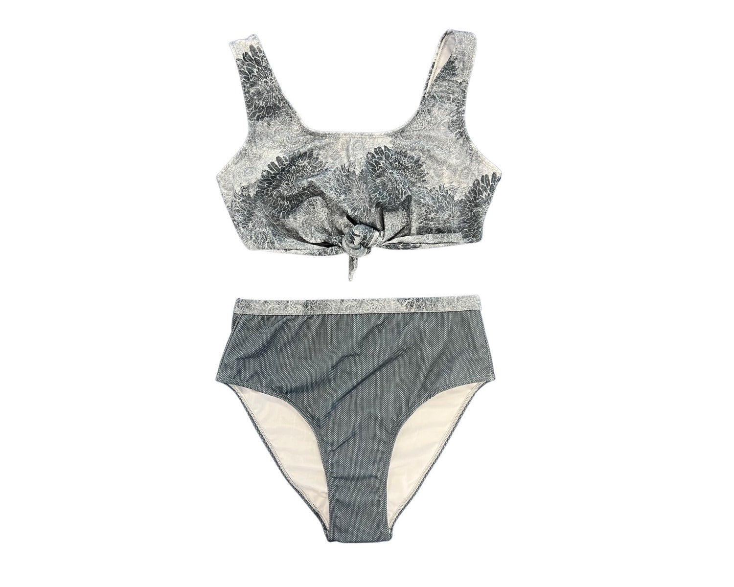 Olga Valentine Swimwear&#39;s Mandala Tie Front Teen Bikini in Grey. The top of the bikini features a grey mandala flower pattern. The bikini bottom features a similar design around the waist and is also grey.